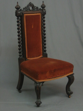 A Victorian mahogany nursing chair with spiral turned decoration to the sides, raised on French cabriole supports