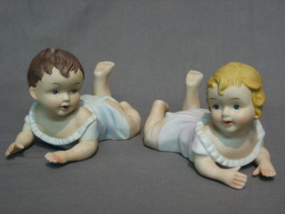 A pair of biscuit porcelain piano babies 5"