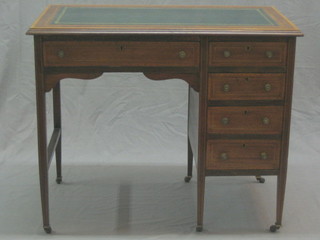 An Edwardian inlaid mahogany desk with inset green leather writing surface, fitted 1 long drawer flanked by 6 short drawers and raised on square tapered supports 36"