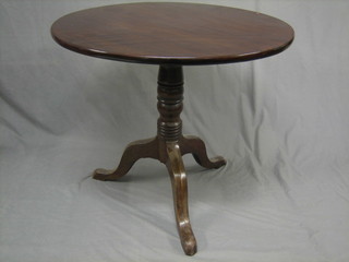 A 19th Century circular mahogany snap top tea table, raised on pillar and tripod supports 32"