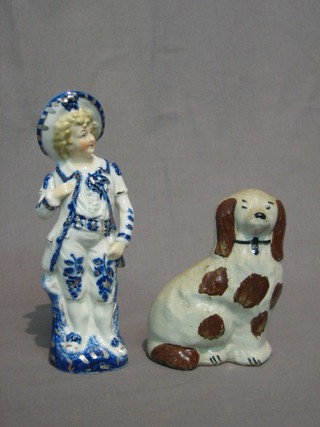 A Staffordshire figure of a Spaniel 4" and a Continental porcelain figure of a standing boy 7"