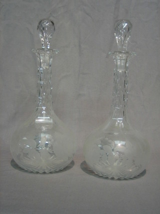 A pair of Victorian glass club shaped decanters etched roses