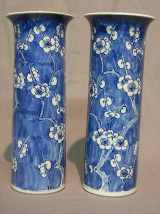 A pair of Oriental blue and white vases decorated prunus, the base with 4 character mark 10" (1 with chip to rim)