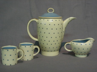 A Susie cooper 6 piece coffee service comprising coffee pot, sugar bowl, cream jug, 6 coffee cans and saucers with white background and blue stylised polka dots, the base marked Susie Cooper England 1688
