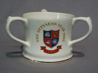 A Guiness 1983 limited edition 3 handled tyg decorated The Arms of the Licence Victualler's School 5"