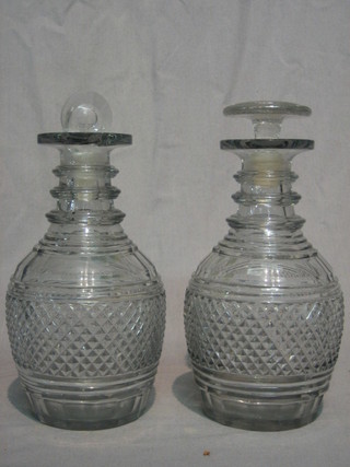 A pair of 18th Century mallet shaped decanters and stoppers (1 replacement stopper and 1 chipped to rim)