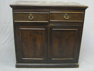 An 18th/19th Century Continental oak cabinet, fitted 2 drawers above a double cupboard, raised on a platform base 36"