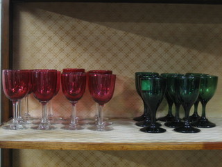 12 various cranberry wine glasses with clear glass stems and 8 19th Century green glass wine glasses