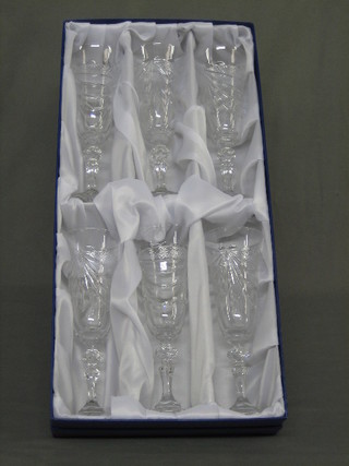 A set of 6 glass champagne flutes, boxed