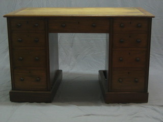 An Edwardian walnut kneehole pedestal desk with inset tooled leather writing surface above 1 long and 8 short drawers 48"