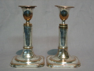 A pair of Sheffield plate adjustable candle sticks with detachable sconces marked Khanards patent 7"