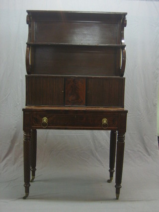 A Scottish William IV mahogany writing table, the raised back fitted 2 shelves, the base enclosed by a tambour shutter, the base fitted a drawer with inset writing surface raised on spiral turned supports ending in brass caps and castors 35"
