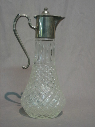 A moulded glass claret jug with silver plated mounts