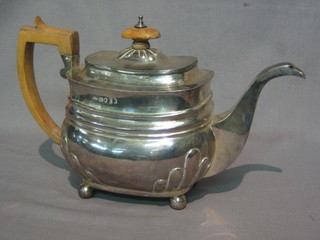 A George III oval shaped silver teapot with demi-reeded decoration, raised on 4 bun feet, London 1812 16 ozs