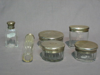 2 circular cut glass dressing table jars with silver lids, London 1935 with Jubilee mark 3" and 2" together with a glass pin jar, a circular glass jar, an oval do. and scent bottle, all with matching silver lids London 1923