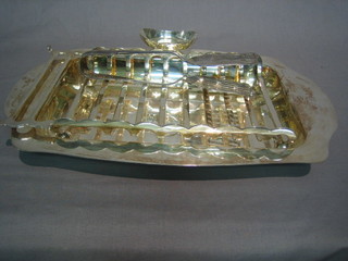 A rectangular silver plated asparagus dish complete with servers