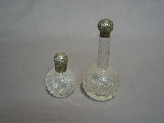 A cut glass scent bottle of club form with embossed silver lid and 1 other (2)