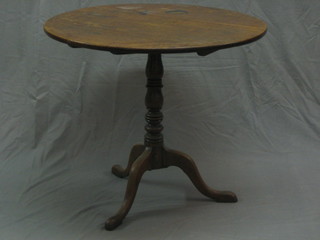 A 19th Century oak circular snap top tea table, raised on pillar and tripod supports 32"