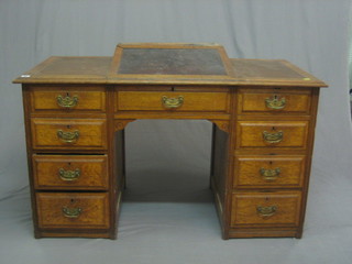 A Victorian oak kneehole pedestal desk, the upper section with hinged writing slope, the pedestal fitted 9 drawers 48"