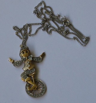 A gold pendant in the form of a unicycling monkey with movable arms and wheel, set numerous diamonds hung on a fine gold chain