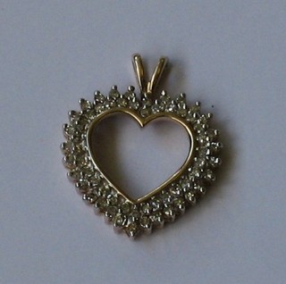 A 9ct gold heart shaped pendant set numerous diamonds