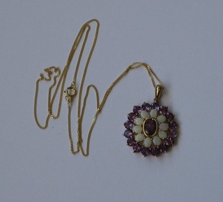 A 9ct gold pendant set amethyst and an opal hung on a gold chain