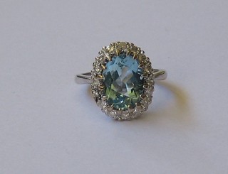 A lady's 18ct white gold dress ring set an oval topaz supported by numerous diamonds