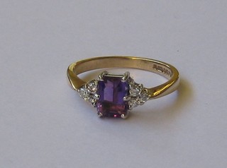 A lady's 9ct gold dress ring set an amethyst supported by diamonds