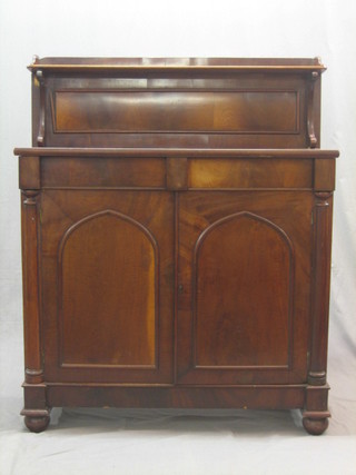 A 19th Century mahogany chiffonier with raised back, the base fitted 2 drawers above a double cupboard enclosed by arch shaped panelled doors 39"
