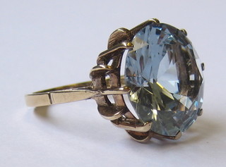 A 9ct gold dress ring set a circular blue cut stone