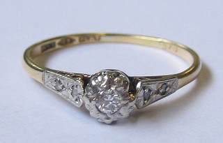 A lady's 18ct gold ring set a sapphire and illusion cut diamond