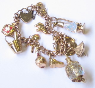 A lady's 9ct gold curb link charm bracelet with heart shaped padlock clasp, hung 13 various charms