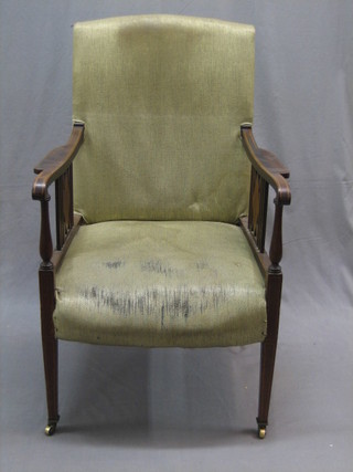 An Edwardian inlaid mahogany open arm chair with upholstered seat and back, raised on square tapering supports