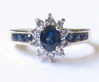 A lady's gold dress ring set a circular cut sapphire surrounded by diamonds