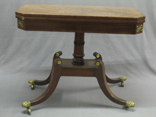 A 19th Century lozenge shaped card table with crossbanded and inlaid top, raised on a turned with platform base and splayed feet ending in brass caps and castors 36"