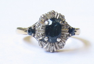 A lady's gold dress ring set an oval cut sapphire surrounded by small diamonds 
