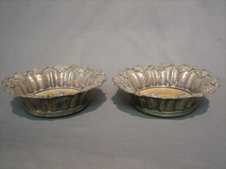A good pair of Georgian silver plated bottle coasters with cast vinery borders and silver buttons to the middle 8"