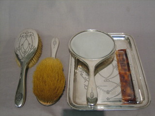 A 5 piece silver backed dressing table set comprising rectangular engraved dressing table tray, 2 hair brushes, hand mirror, clothes brush and comb, Chester 1916 and 1917