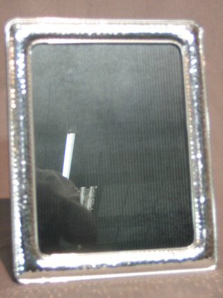 A silver photograph frame with hammered finish