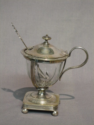 An Edwardian Georgian style cut glass mustard pot contained in a silver frame