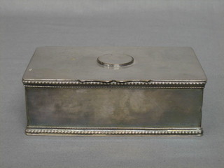 A silver plated cigarette box with hinged lid 5 1/2"