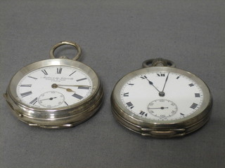 An open faced pocket watch by Kendal & Dent contained in a silver case and 1 other silver cased open pocket watch (2)