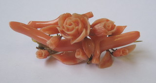 A coral brooch in the form of flower heads 2"
