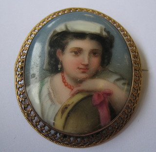 A Victorian porcelain brooch decorated a head and shoulders portrait of a lady contained in a gilt metal mount