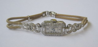A lady's platinum cocktail wristwatch set numerous diamonds