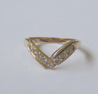A 9ct gold wish bone ring set diamonds