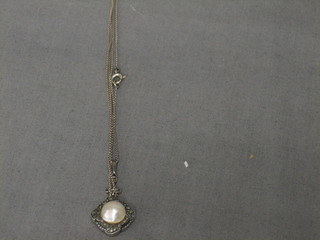 A marcasite pendant set a pearl hung a fine chain