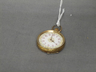 An open faced fob watch contained in a 14ct gold case