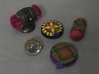 2 treen Tartanware pin cushions, a wooden pin cushion and a parquetry pin cushion, together with a gilt metal locket