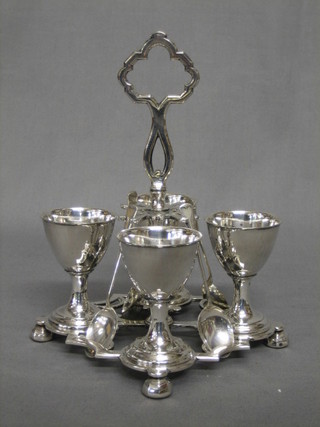 A silver plated 4 piece egg cruet and 4 silver spoons